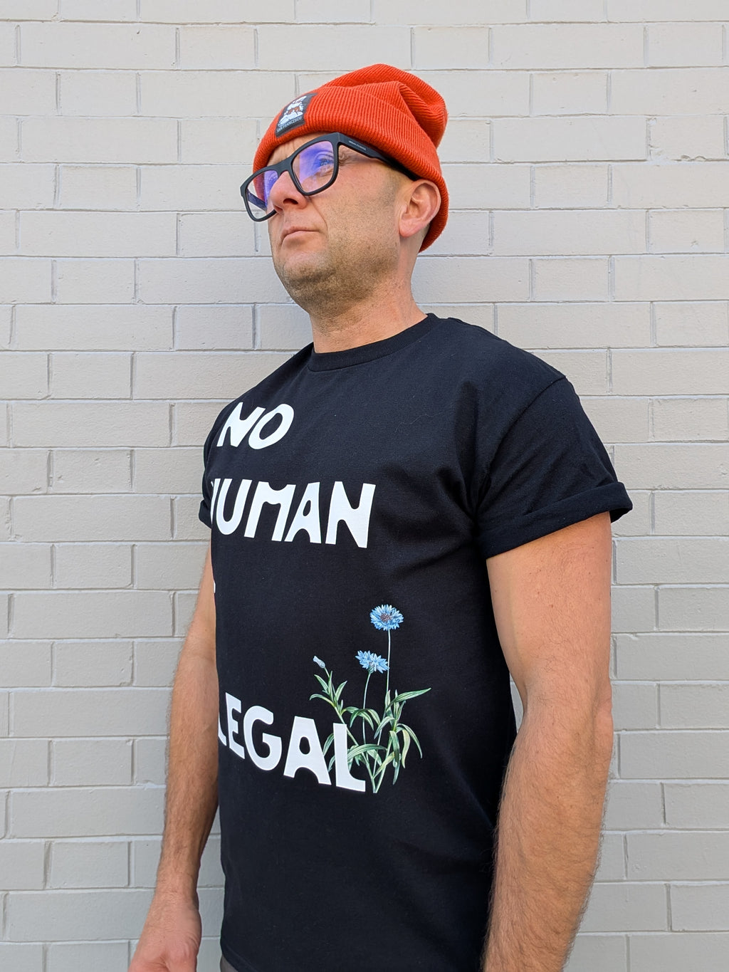 A. NO HUMAN IS ILLEGAL T-SHIRT-LOCAL ARTIST