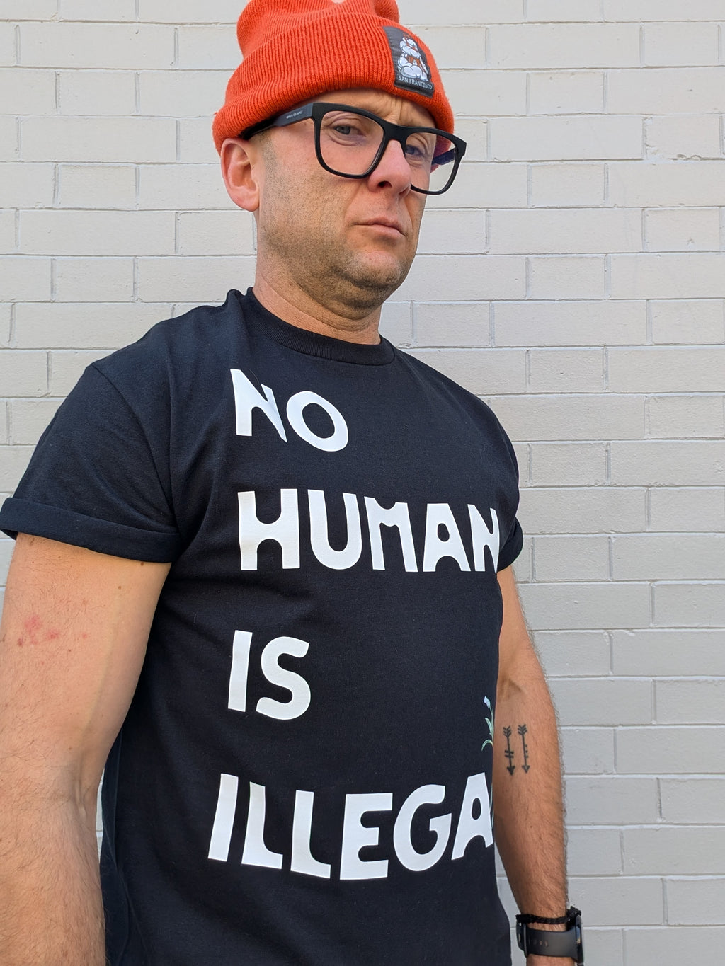 A. NO HUMAN IS ILLEGAL T-SHIRT-LOCAL ARTIST