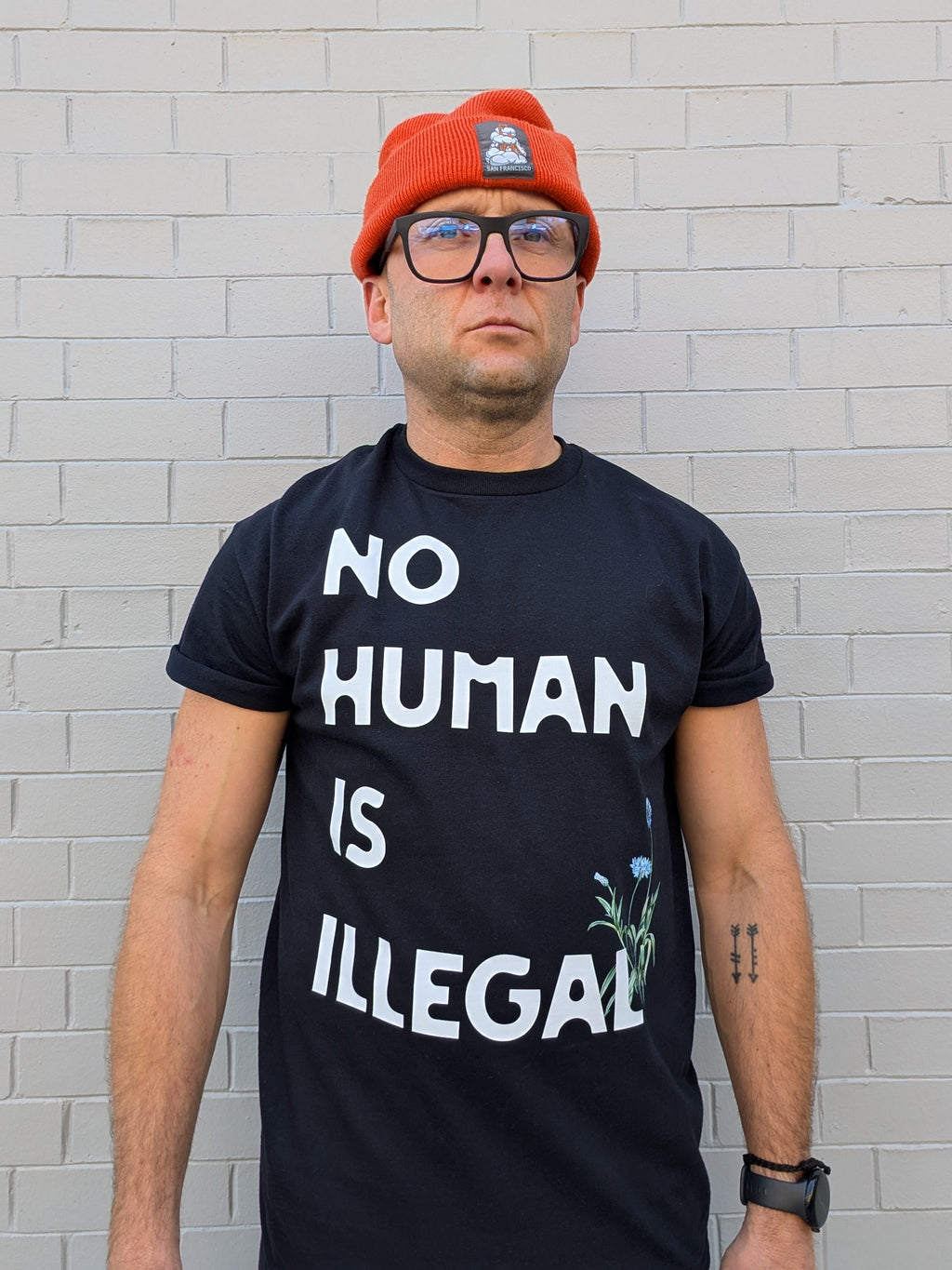 A. NO HUMAN IS ILLEGAL T-SHIRT-LOCAL ARTIST